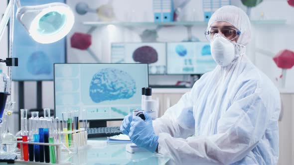 Portrait of Male Chemist Wearing Protective Clothes, Mask and Glasses alt