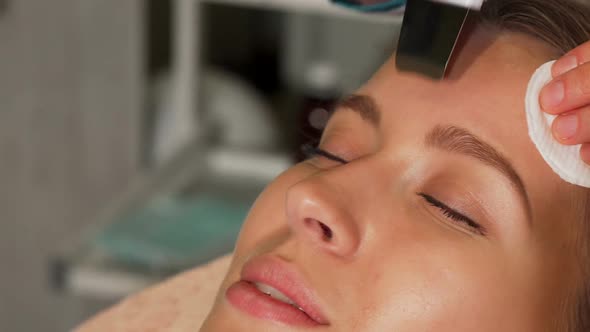 Young Woman Undergoing Ultrasonic Facial Treatment at Beauty Salon 1080p