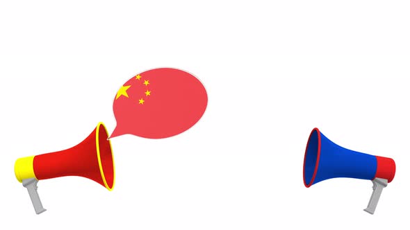 Flags of Russia and China on Speech Bubbles with Loudspeakers