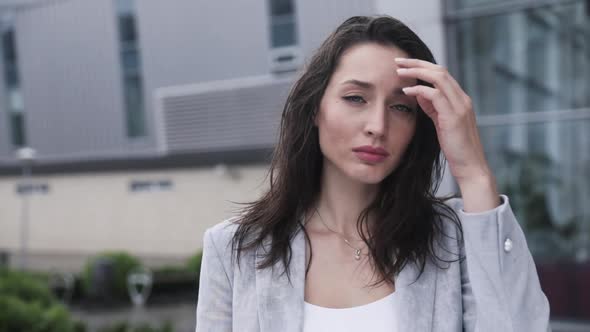 Very Attractive Young Woman with Deep blue Eyes Looking at the Camera.