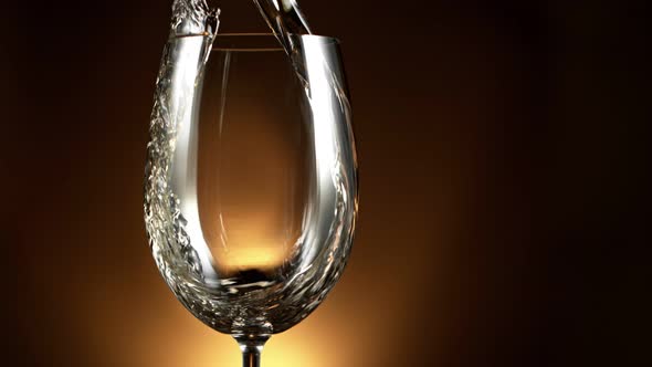 Super Slow Motion Detail Shot of Pouring White Wine on Luxury Gradient Background at 1000Fps