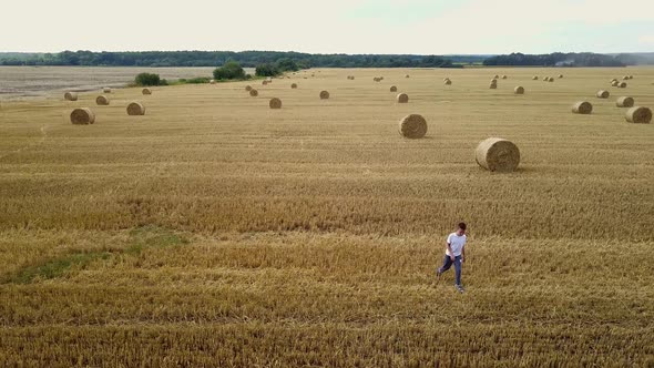Little Boy In Field. Beautiful boy walking in a field with straw