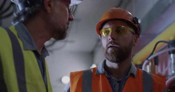 Engineer Speaking with Supervisor on Power Station