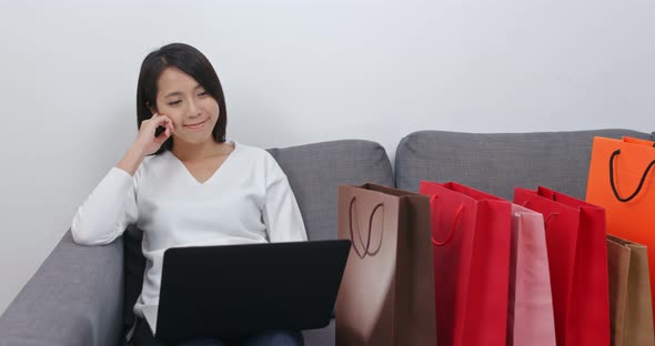 Woman make online shopping on laptop computer at home