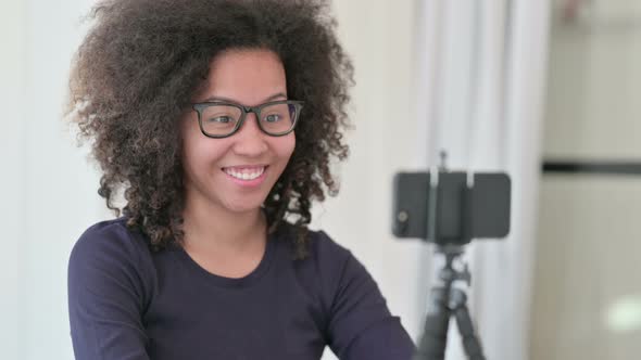 African Woman Recording Video on Smartphone