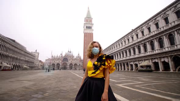 Model in Dress and Medical Mask Poses on Empty Venice Square