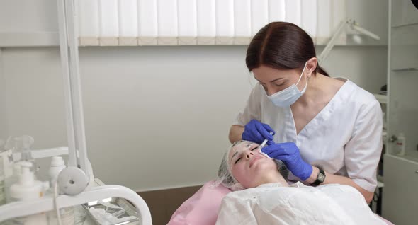 Female Cosmetologist Makes Rejuvenating Botox Anti Wrinkle Injections on the