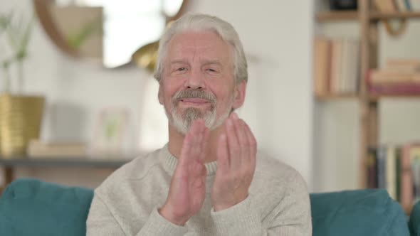 Positive Old Man Clapping at Home
