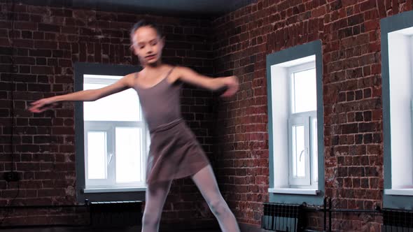 A Ballerina Girl Performing Dancing Moves in the Studio  Raising Her Legs and Jumping