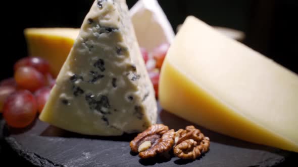 Assorted Cheeses with Nuts and Dried Fruits on the Table. Rotating Video