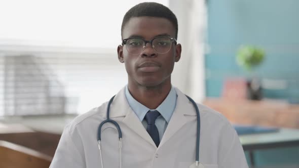 Serious Young African Doctor Looking at the Camera