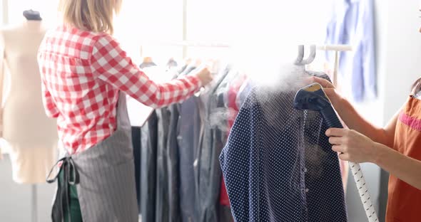 Woman Seamstress Ironing Shirt Using Steamer in Tailor Shop  Movie Slow Motion