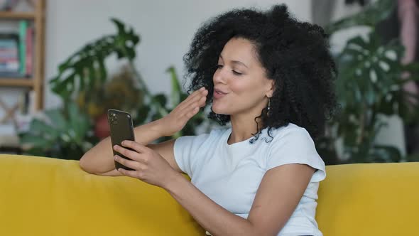 Portrait of a Young African American Woman Talking on a Video Call on Her Smartphone