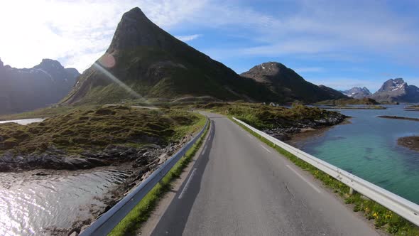 Driving a Car on a Road in Norway Lofoten