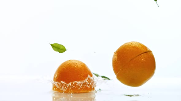 Fresh Oranges Dropped Into Water with Splash Shooted with High Speed Cinema Camera at 1000 Fps