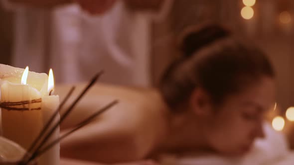 Massage Therapist Dredge Salt on Girl Lying on Table in Spa Resort in Slowmotion