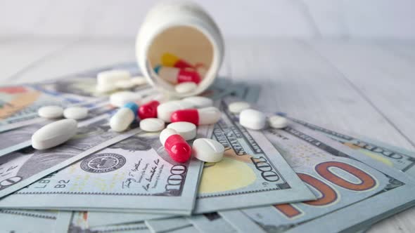 Healthcare Cost Concept with Us Dollar , Container and Pills on Table 