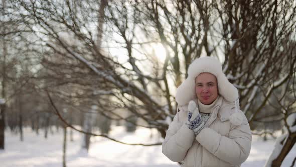 Portrait of a Cute Homosexual on a Winter Walk in a City Park in Warm Clothes