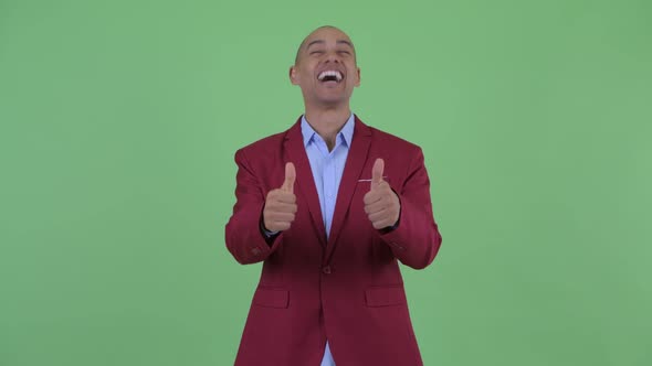 Happy Bald Multi Ethnic Businessman Giving Thumbs Up and Looking Excited