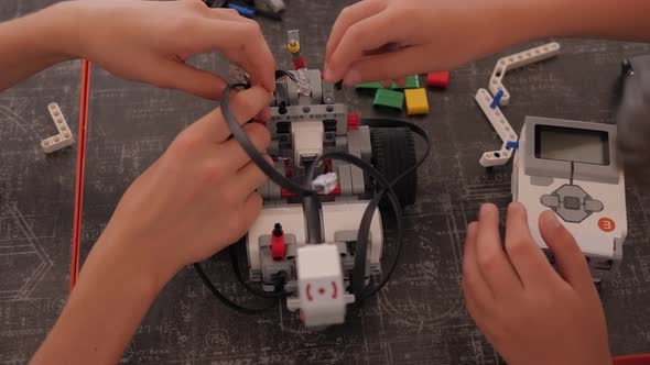 Close-up Group of Children Are Making Robots in School of Robotics.