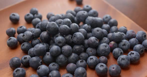 blueberry on wooden plate