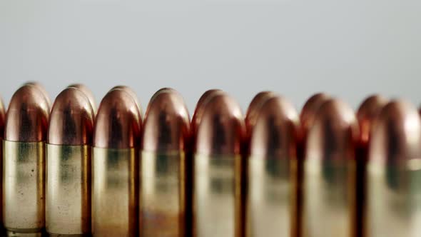 Close up of many ammunition are arranged in a row and rotated with a rotating platform. Slow Motion