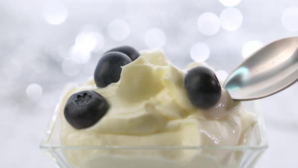 spoon of whipped mascarpone cream and blueberries 