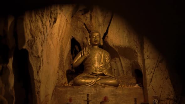 Statue of Buddha Showing Sacral Murda in Niche in Cave