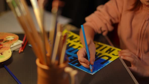 Closeup Help Ukrainian Children Poster with Hands of Little Girl Painting
