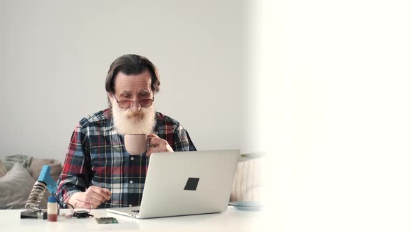 Modern Senior Man Working on Laptop at Home