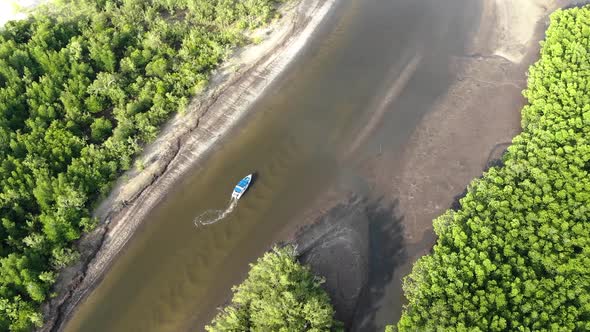 Aerial view of small boat riding on river in Thailand