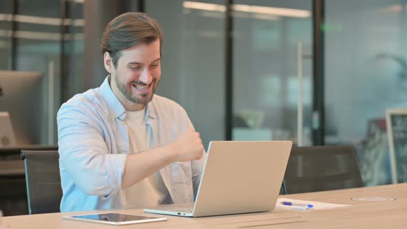 Successful Man Celebrating on Laptop