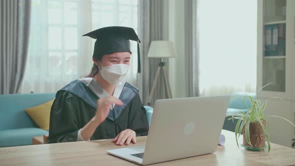 Asian Woman Wearing Protection Face Mask Having Video Call In Living Room