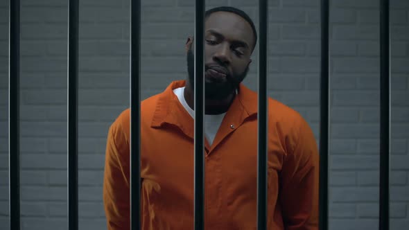 Impudent Black Prisoner in Cell Looking Directly to Camera, Dangerous Criminal