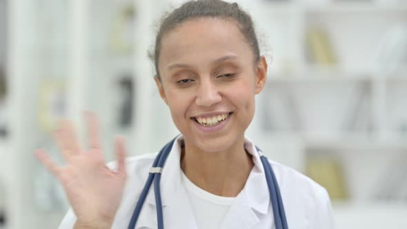 Portrait of Friendly Young African Doctor Talking on Video Call 