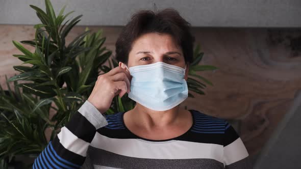 Portrait of a Young Woman with Mask at Home