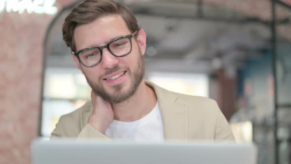 Close Up of Man with Laptop Having Neck Pain