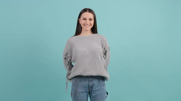 Pretty Girl Looking at Camera with a Smile, Isolated on Red Background.