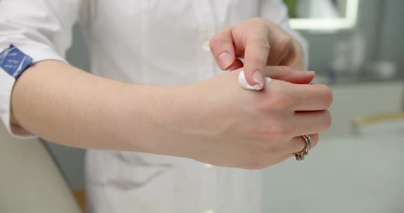 Beautician Applies Cream On Hand In A Beauty Salon. Beauty Clinic Concept