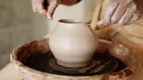 The Female Potter Cuts the Base of the Vase with a Fishing Line and Split the Vase Into Two Half