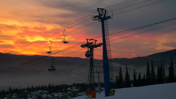 ski resort lift over small houses against hilly landscape