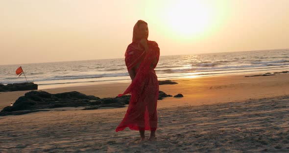 Young Women Wearing a Red Saree on the Beach Goa India