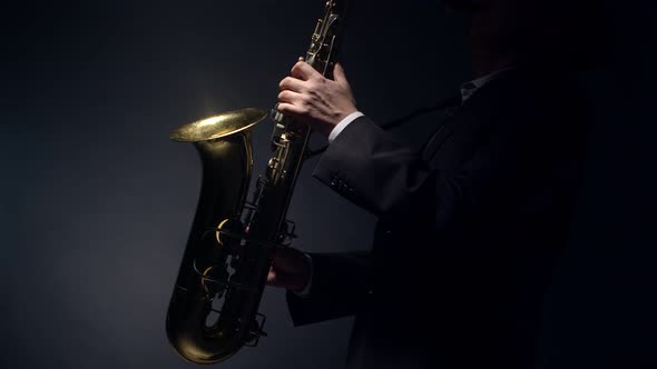 Man Musician Plays the Saxophone in Profile Studio