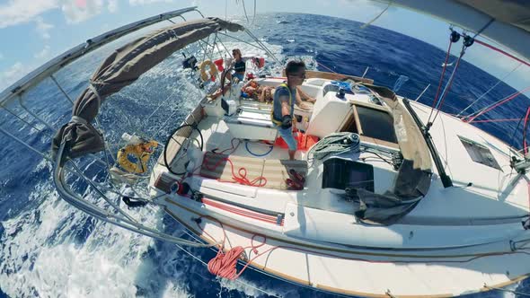 A Yacht with a Group of People on It Is Sailing on Autopilot