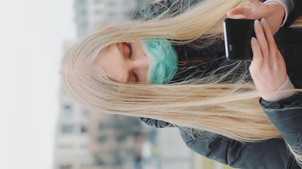 Medium Shot of Girl Wearing Medical Mask Reading Outbreaking News About Coronavirus Disease