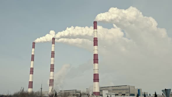 Smoke From the Chimneys of a Thermal Power Plant Against the Background of the Winter Sky