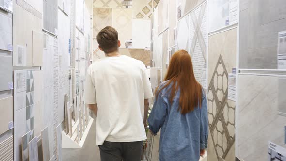 Good-looking Couple in Market Aisle, Looking for Things They Need.