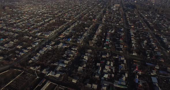 Tilt up Drone camera movement on top of Karakol city by a sunny morning.