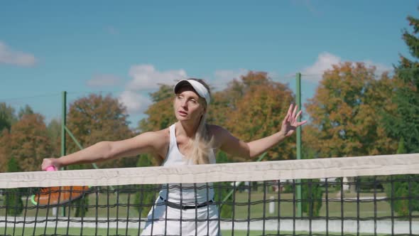 Pro Female Tennis Player Hits the Ball with a Racket Female Hits Off the Opponent's Serves During