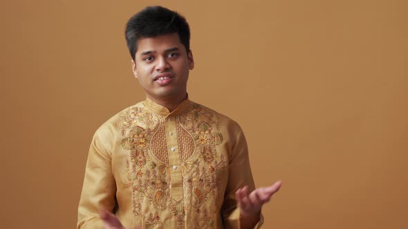 Serious Indian man in national cloth talking with camera